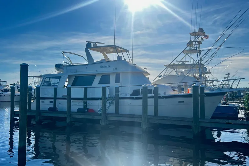 Slide: The Image of 1984 Hatteras 61 Cockpit MY helm with steering wheel, controls, and navigation equipment. - 40