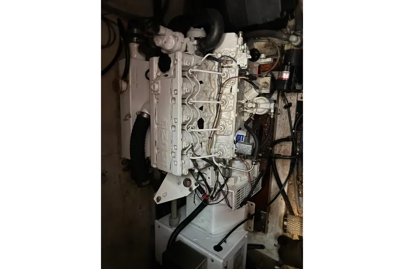 Slide: The Image of Engine compartment of a 1984 Hatteras 61 Cockpit MY yacht, showcasing detailed machinery. - 50