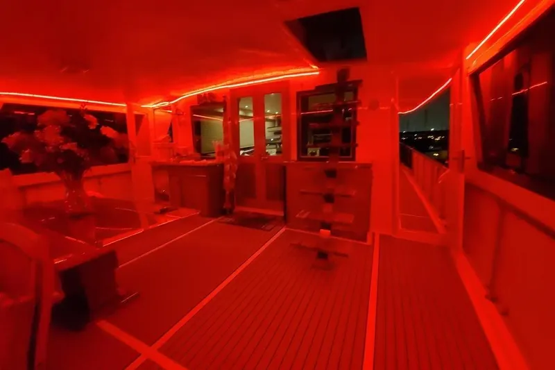 Slide: The Image of Luxurious 1984 Hatteras 61 Cockpit MY yacht deck with elegant seating and ambient lighting. - 8