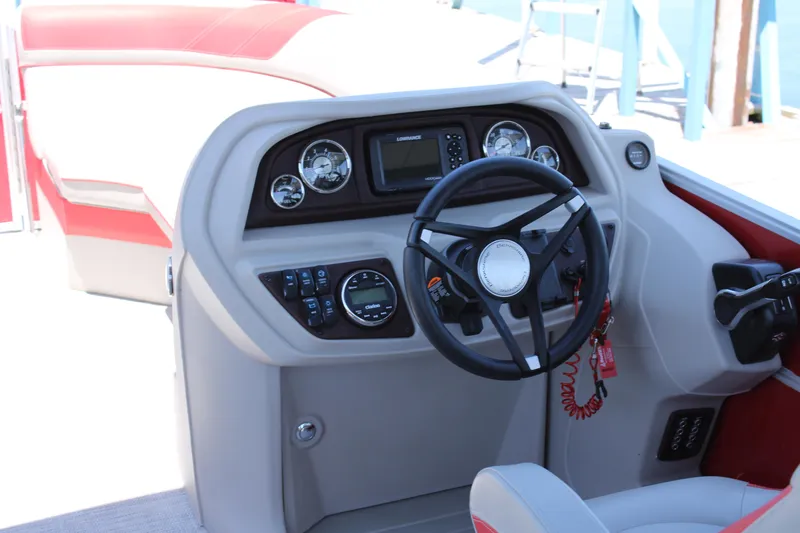 Slide: The Image of 2024 Berkshire 24RFX LE boat dashboard with steering wheel and control panel. - 7