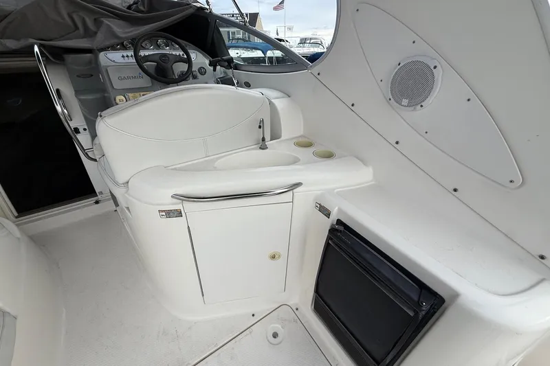 Slide: The Image of 2004 Maxum 3100 SE boat interior with helm, sink, and storage. - 10