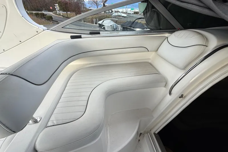 Slide: The Image of 2004 Maxum 3100 SE boat interior with white cushioned seating area. - 11