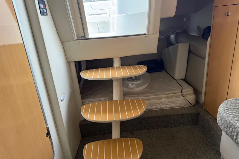 Slide: The Image of Interior of 2004 Maxum 3100 SE boat with wooden steps and cozy seating area. - 18