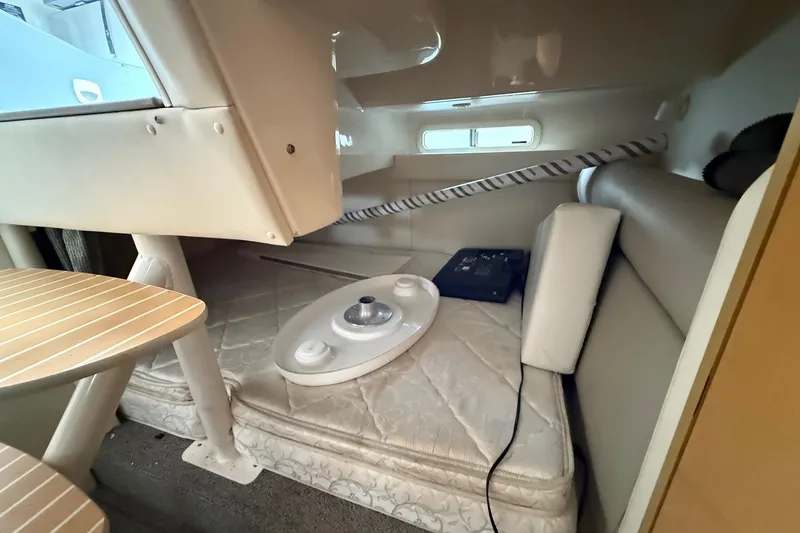 Slide: The Image of 2004 Maxum 3100 SE cabin interior with seating and table setup. - 19