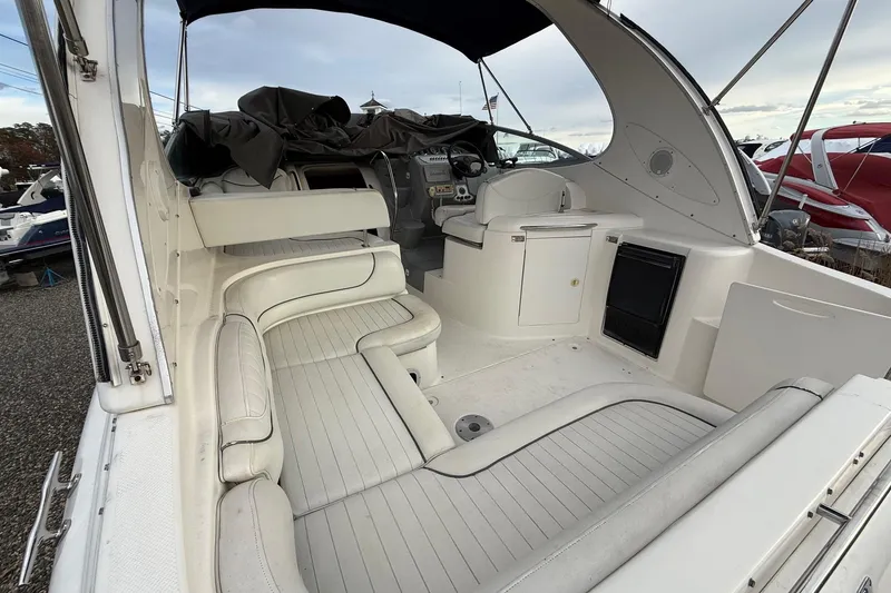 Slide: The Image of 2004 Maxum 3100 SE boat interior with white seating and helm station. - 2