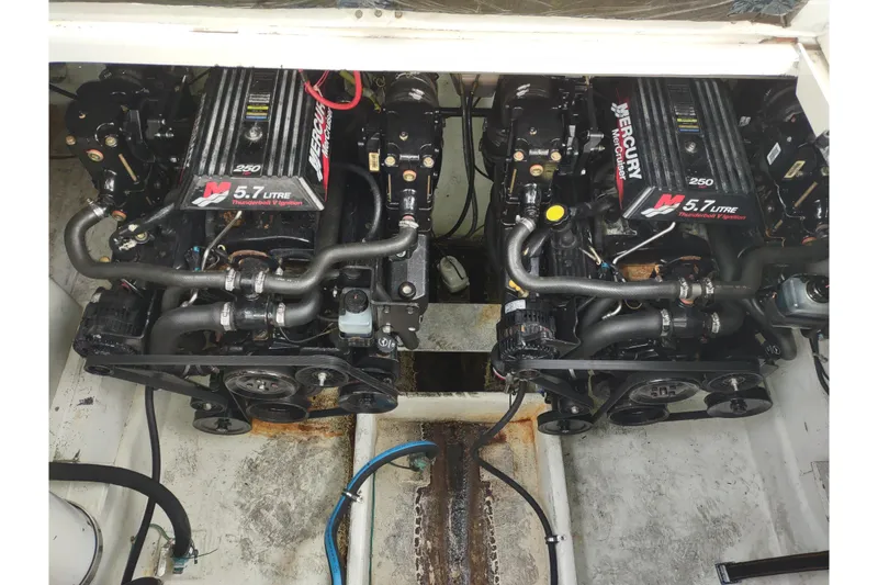 Slide: The Image of Twin Mercury 5.7L engines in a 2004 Maxum 3100 SE boat. - 24