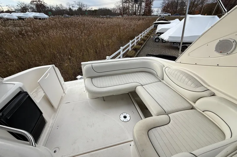 Slide: The Image of 2004 Maxum 3100 SE boat interior with white seating and outdoor view. - 4