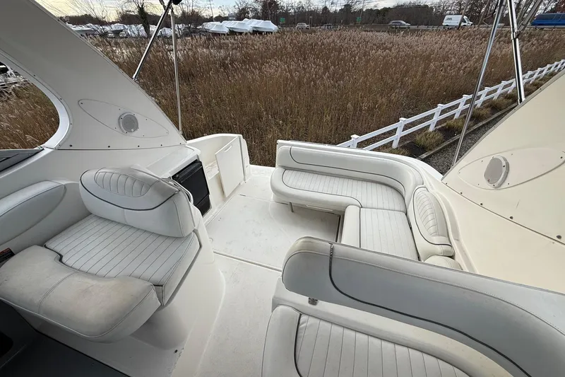 Slide: The Image of 2004 Maxum 3100 SE boat interior with white seating and outdoor view. - 5