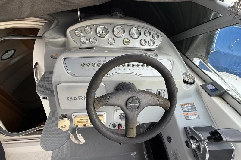 Slide: The Image of 2004 Maxum 3100 SE boat dashboard with steering wheel and control panel. - 8