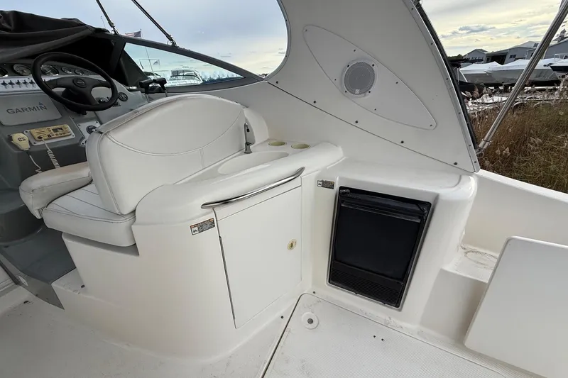 Slide: The Image of 2004 Maxum 3100 SE boat interior with helm, seating, and storage compartments. - 9