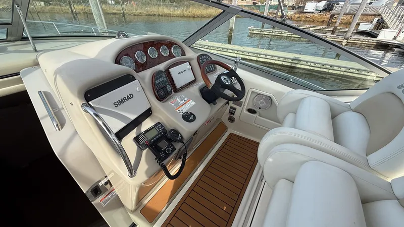 Slide: The Image of 2008 Sea Ray 340 Sundancer helm with modern controls and wood accents. - 13