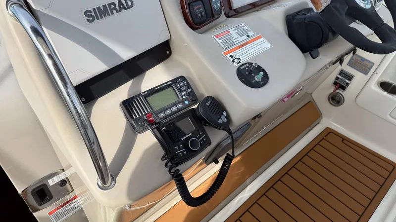 Slide: The Image of Control panel of 2008 Sea Ray 340 Sundancer with Simrad electronics and marine radio. - 14