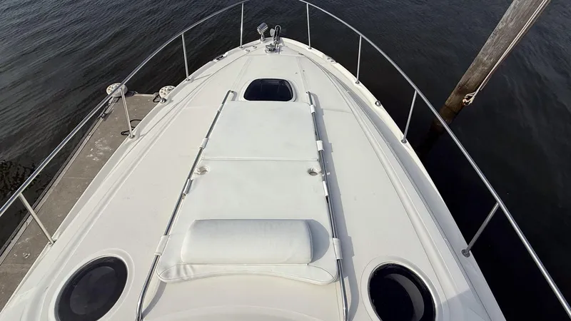 Slide: The Image of Bow view of 2008 Sea Ray 340 Sundancer docked, showcasing sleek design and deck features. - 19