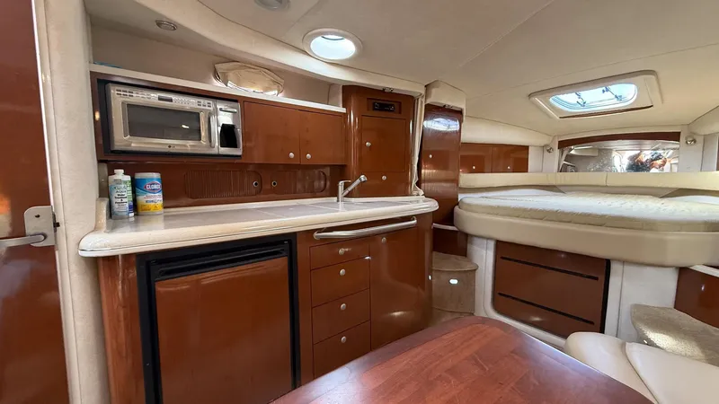 Slide: The Image of Interior of 2008 Sea Ray 340 Sundancer yacht with kitchenette and bed. - 24