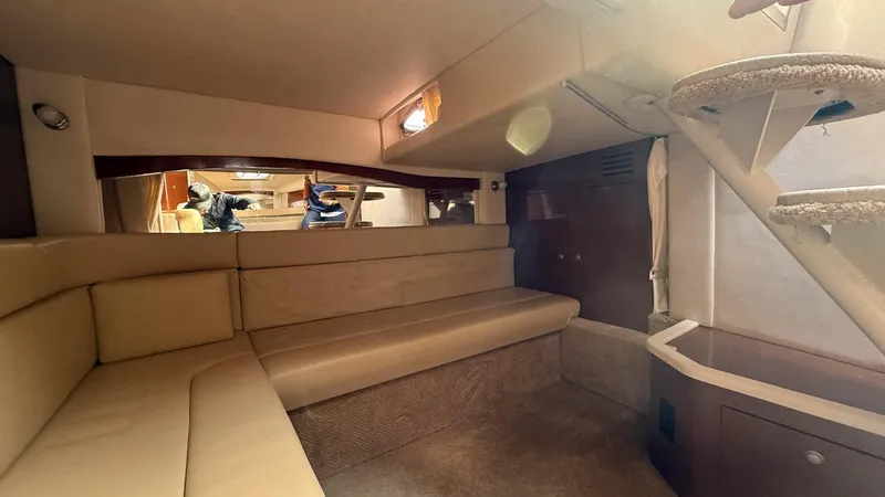 Slide: The Image of 2008 Sea Ray 340 Sundancer cabin interior with beige seating and stairs. - 27