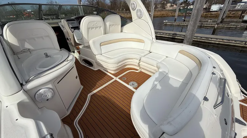 Slide: The Image of 2008 Sea Ray 340 Sundancer boat interior with white seating and wood flooring. - 5