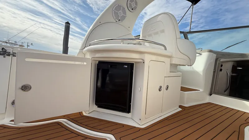 Slide: The Image of 2008 Sea Ray 340 Sundancer boat interior with mini fridge and seating area. - 7