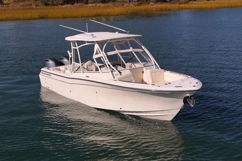 The Image of 2023 Grady-White Freedom 275 boat on calm water, showcasing sleek design and dual engines. - 0