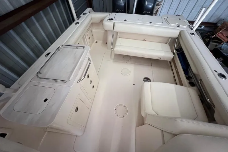 Slide: The Image of 2023 Grady-White Freedom 275 boat interior with seating and storage compartments. - 10