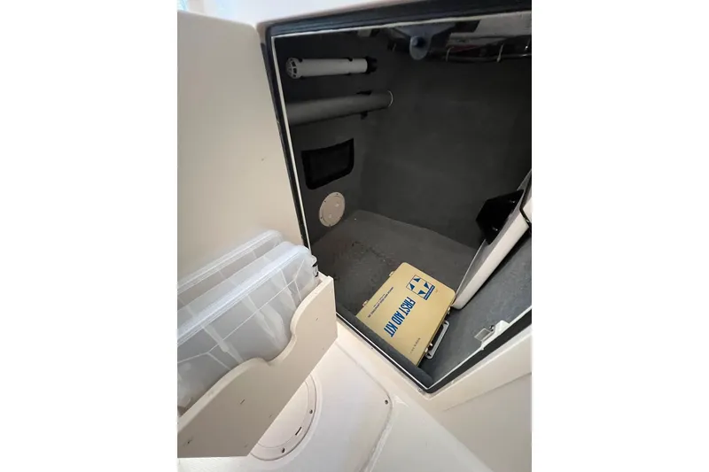 Slide: The Image of 2023 Grady-White Freedom 275 storage compartment with manual and organizer. - 16
