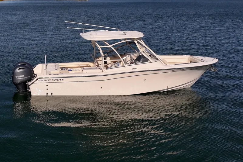 Slide: The Image of 2023 Grady-White Freedom 275 boat on calm water, side view. - 2