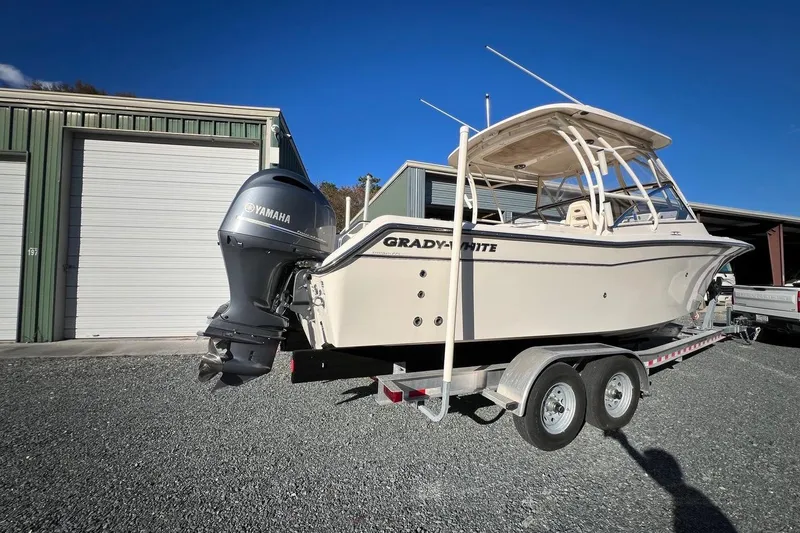 Slide: The Image of 2023 Grady-White Freedom 275 boat on trailer with Yamaha engine, parked outdoors. - 24