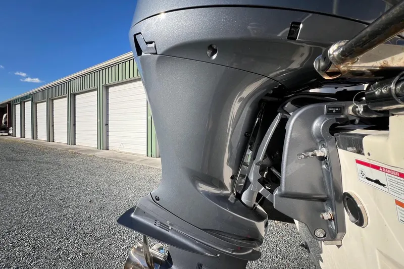 Slide: The Image of Close-up of a 2023 Grady-White Freedom 275 boat motor near storage units. - 26