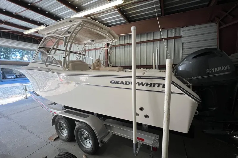 Slide: The Image of 2023 Grady-White Freedom 275 boat on trailer in storage facility. - 31