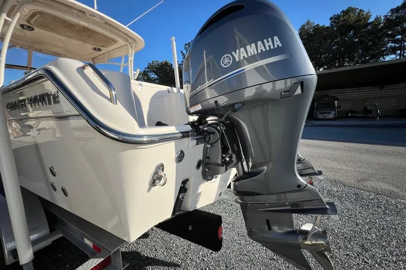 Slide: The Image of 2023 Grady-White Freedom 275 boat with Yamaha outboard motor, parked on gravel. - 33