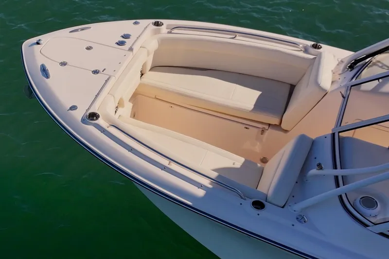 Slide: The Image of 2023 Grady-White Freedom 275 boat, spacious seating, on calm green water. - 5