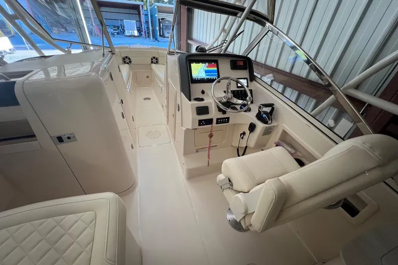 Slide: The Image of 2023 Grady-White Freedom 275 boat interior with modern helm and seating. - 7