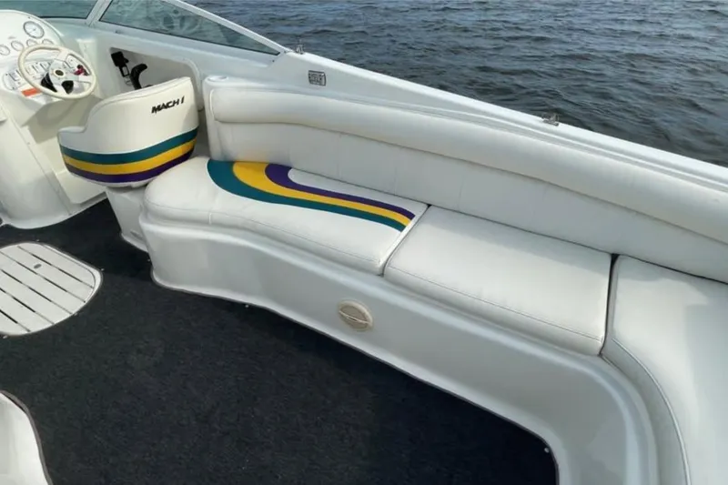 Slide: The Image of Interior of 2000 Baha MACH 1 boat with white seating and colorful accents. - 12