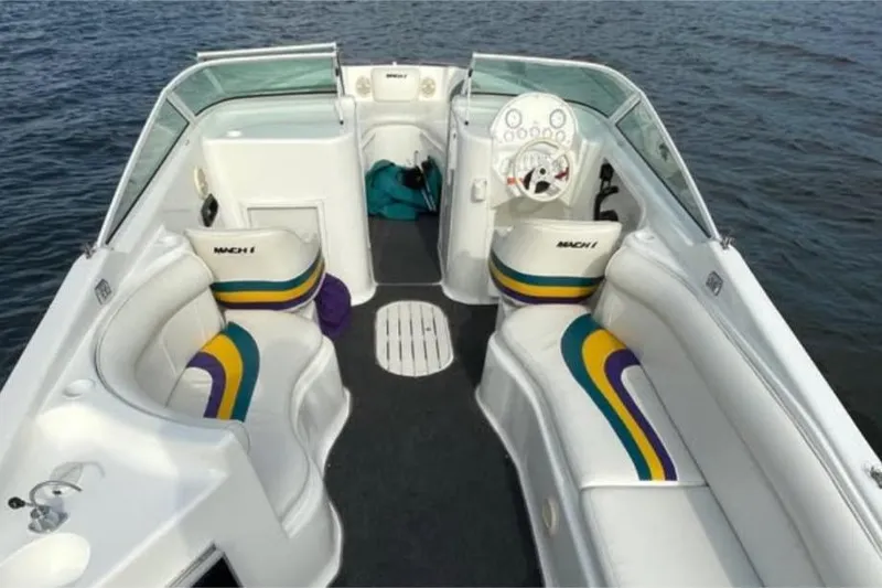 Slide: The Image of Interior of 2000 Baha MACH 1 boat with colorful seating and steering wheel. - 13