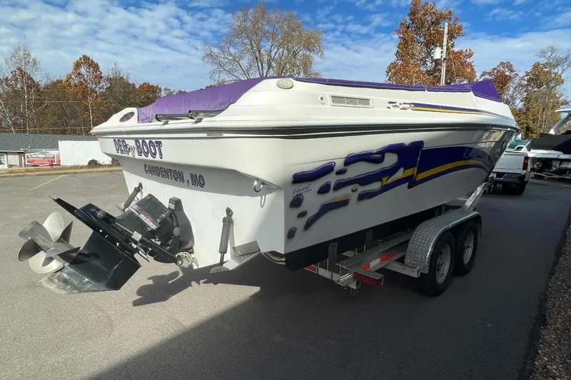 Slide: The Image of Baha MACH 1 boat on trailer, Camdenton, MO, vibrant graphics, clear sky background. - 5