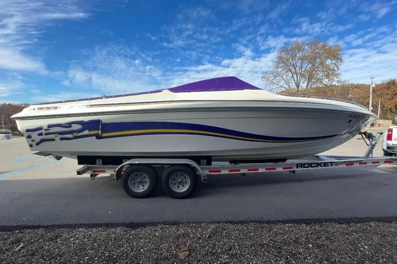 Slide: The Image of 2000 Baha MACH 1 boat on trailer, featuring sleek design and vibrant graphics. - 6