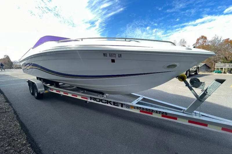 Slide: The Image of 2000 Baha MACH 1 boat on trailer under clear blue sky. - 7