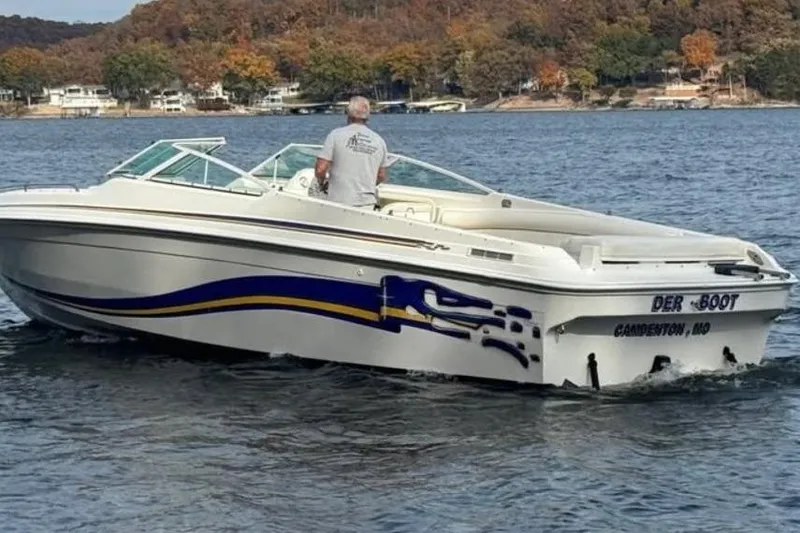 Slide: The Image of 2000 Baha MACH 1 boat cruising on a lake with autumn trees in the background. - 8