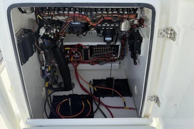 Slide: The Image of Electrical wiring and components inside a 2026 Pathfinder 2200 TRS boat compartment. - 13
