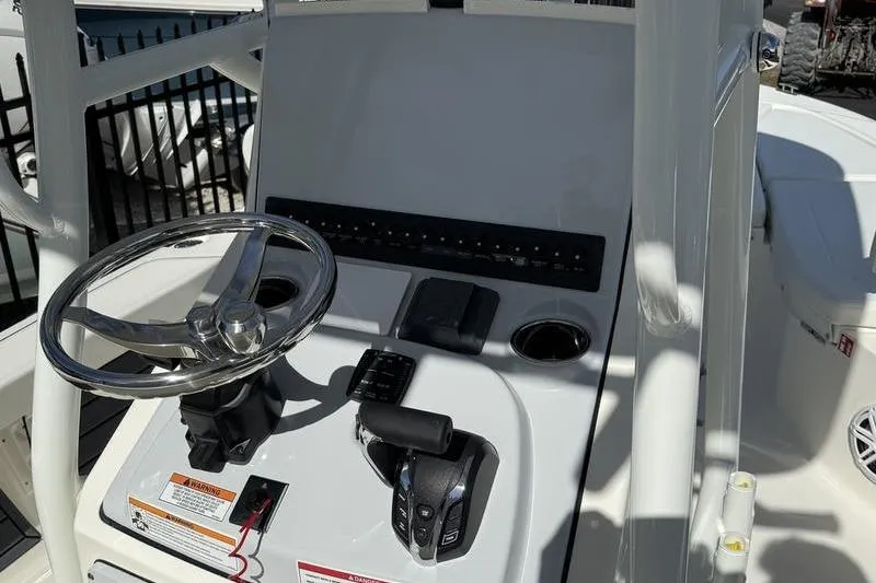 Slide: The Image of Steering console of 2026 Pathfinder 2200 TRS boat with controls and cup holders. - 14