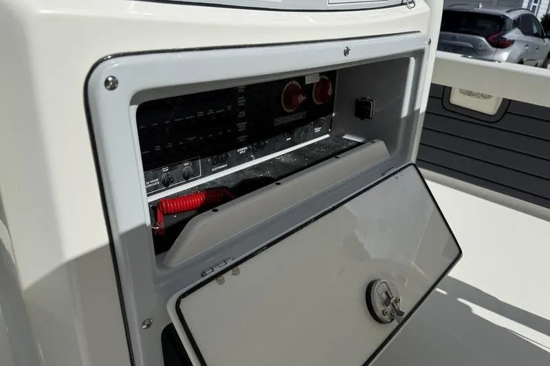 Slide: The Image of 2026 Pathfinder 2200 TRS boat electrical panel with open access compartment. - 16