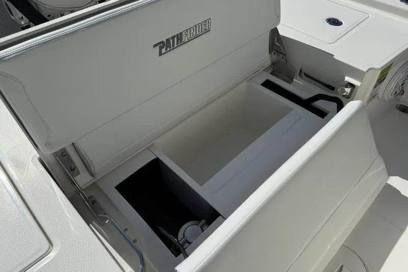 Slide: The Image of 2026 Pathfinder 2200 TRS boat storage compartment with open lid, showcasing interior space. - 22
