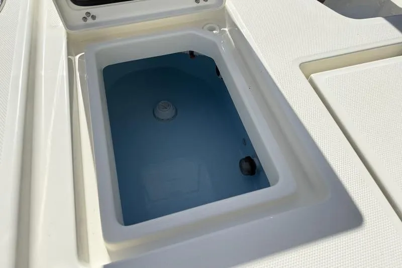 Slide: The Image of Livewell on 2026 Pathfinder 2200 TRS boat, open lid, white interior. - 26