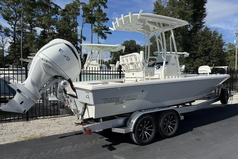 Slide: The Image of 2026 Pathfinder 2200 TRS boat on trailer, featuring Yamaha outboard motor, parked outdoors. - 4