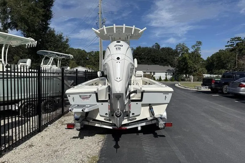 Slide: The Image of 2026 Pathfinder 2200 TRS boat on trailer, parked outdoors under clear sky. - 5