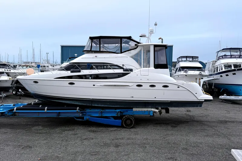 The Image of 2004 Meridian 459 Motoryacht on trailer in marina, surrounded by other boats. - 0