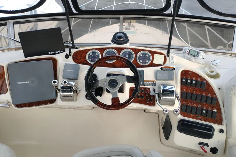 Slide: The Image of 2004 Meridian 459 Motoryacht helm with Raymarine navigation equipment and control panel. - 13