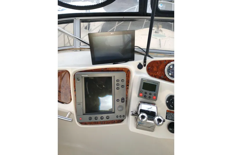 Slide: The Image of 2004 Meridian 459 Motoryacht helm with navigation and control systems. - 17