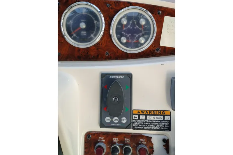 Slide: The Image of Control panel of a 2004 Meridian 459 Motoryacht with gauges and warning labels. - 19