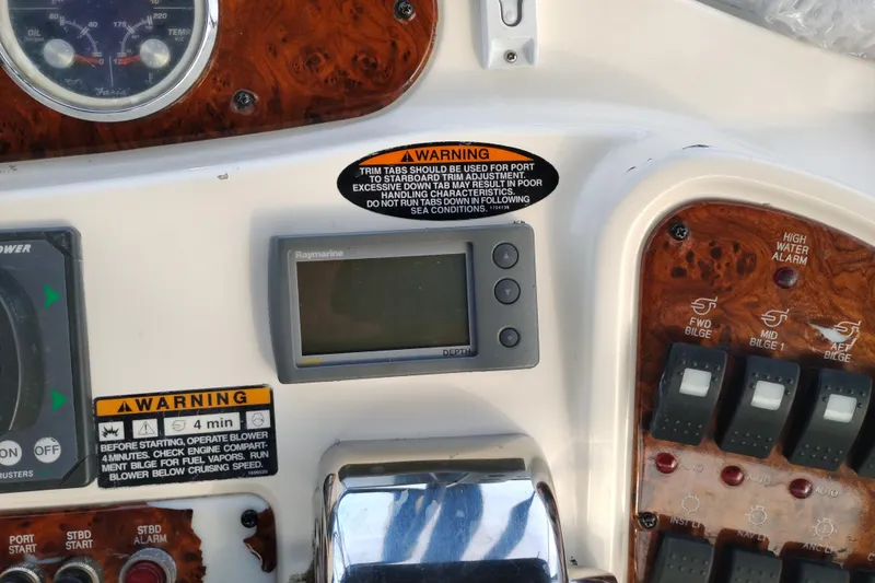 Slide: The Image of Control panel of 2004 Meridian 459 Motoryacht with warning labels and Raymarine display. - 20
