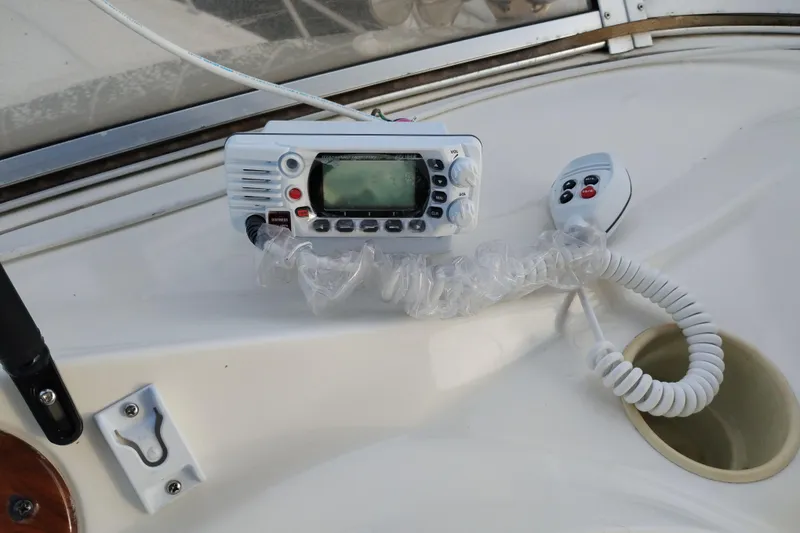 Slide: The Image of VHF radio on 2004 Meridian 459 Motoryacht dashboard, coiled cord visible. - 21